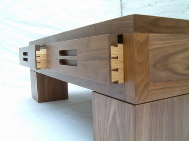 Walnut and oak coffee table showing hand-cut dovetails
